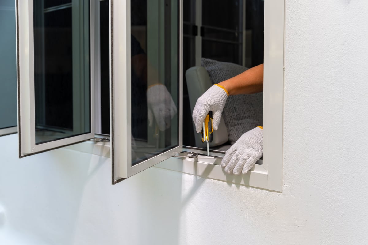 Craftsman adjusting the friction stay on a casement window